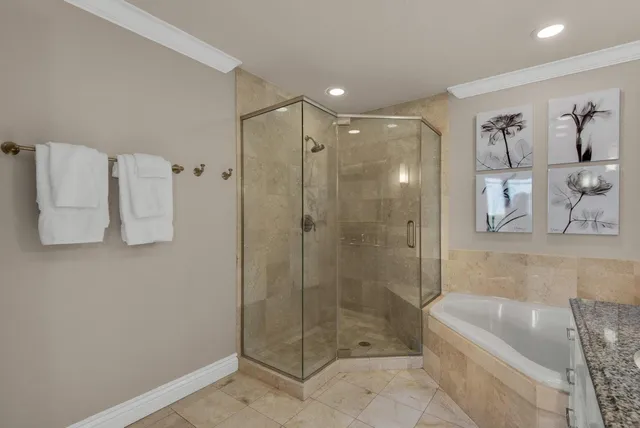 a bathroom with a shower a bathtub and a shower