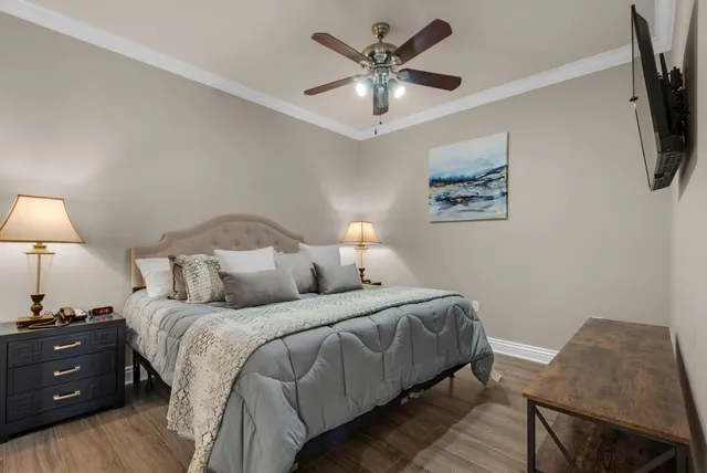 a bedroom with a bed and a lamp on dresser