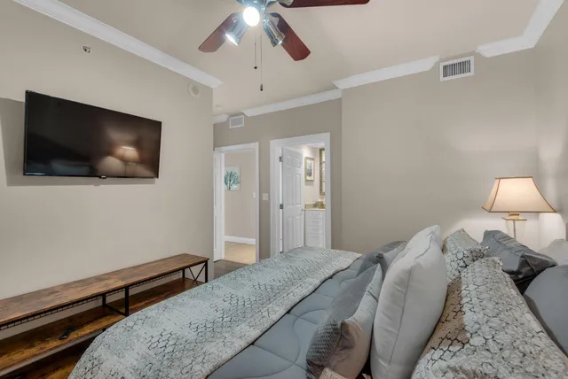 a bedroom with a bed and a flat screen tv