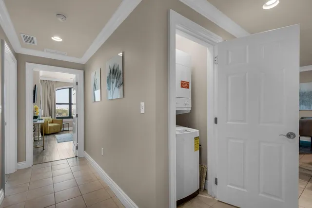 a view of a hallway with bathroom and a bathroom