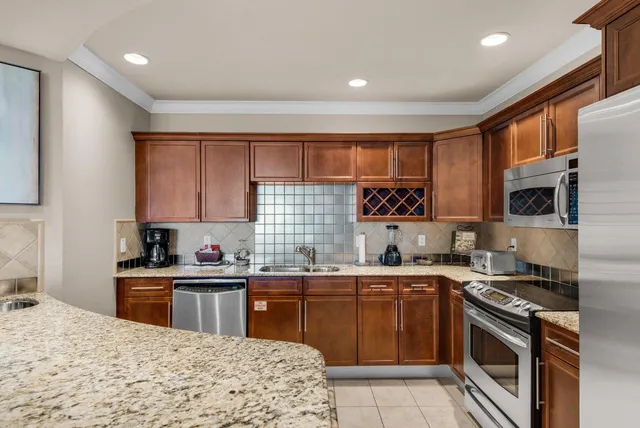 a kitchen with a sink stove top oven and cabinets