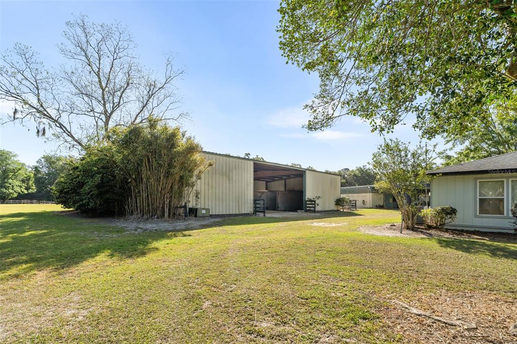 16525 Southwest 5th Place Newberry, FL 32669 - Photo 46 of 55 a view of a swimming pool with a yard and a large tree
