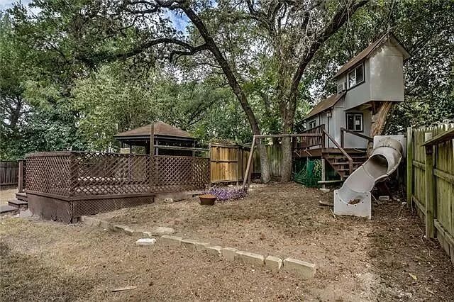 7801 Coldstream Drive Austin, TX 78748 - Photo 15 of 20 Fenced backyard featuring a deck, a playground, a gazebo, and view of scattered trees
