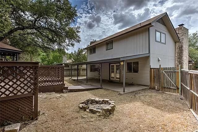 7801 Coldstream Drive Austin, TX 78748 - Photo 2 of 20 Back of house featuring an outdoor fire pit, a fenced backyard, a gate, a chimney, and a patio area