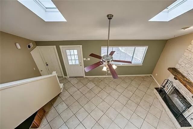 7801 Coldstream Drive Austin, TX 78748 - Photo 7 of 20 Entryway featuring a skylight, light tile patterned floors, and ceiling fan