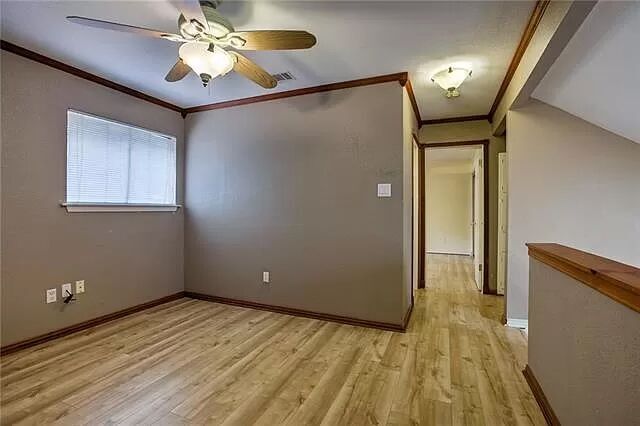 7801 Coldstream Drive Austin, TX 78748 - Photo 10 of 20 Spare room featuring crown molding, light wood-type flooring, and a ceiling fan
