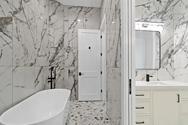 a view of a bathroom with sink and mirror