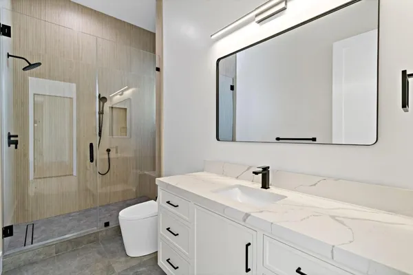 a bathroom with a double vanity sink mirror and