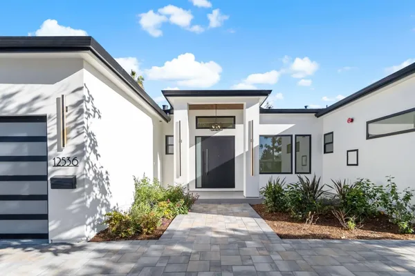 a front view of a house with garden