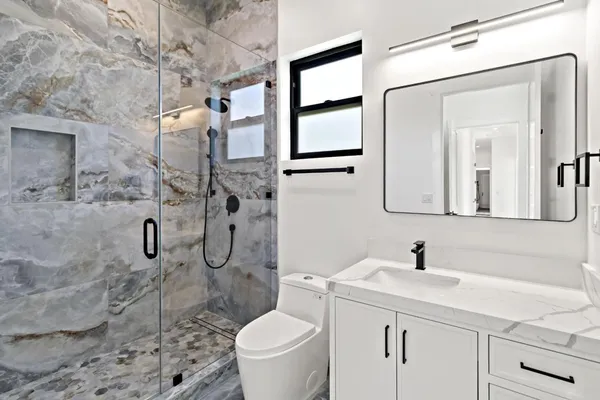 a view of empty room with wooden floor and windows