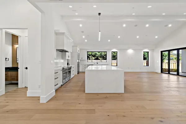 a view of kitchen with kitchen island and stainless steel appliances