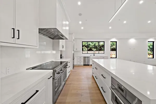 a large kitchen with stainless steel appliances granite countertop a lot of counter space