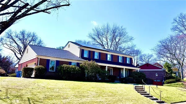 a view of a house with a yard covered in snow