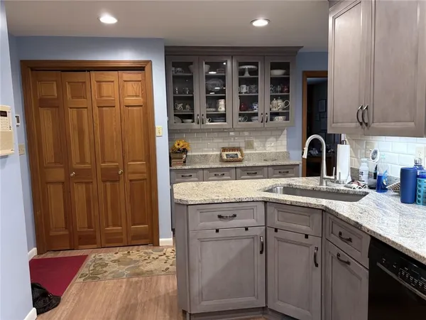 a kitchen with appliances a sink and cabinets