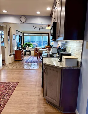 a bathroom with a granite countertop sink toilet a large mirror and shower