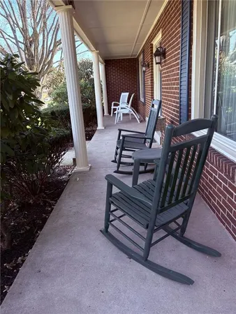 a living room with furniture and a bookshelf