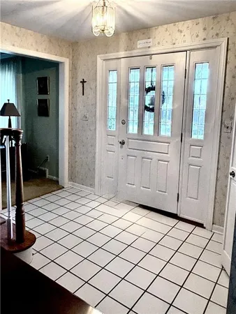 a kitchen with stainless steel appliances granite countertop a table chairs sink and cabinets