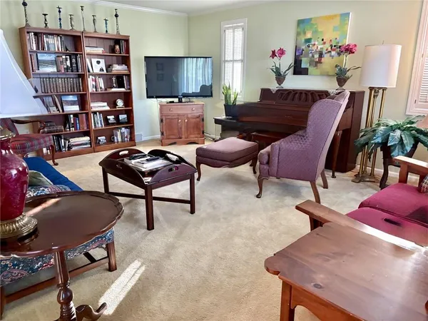 a kitchen with white cabinets and black appliances