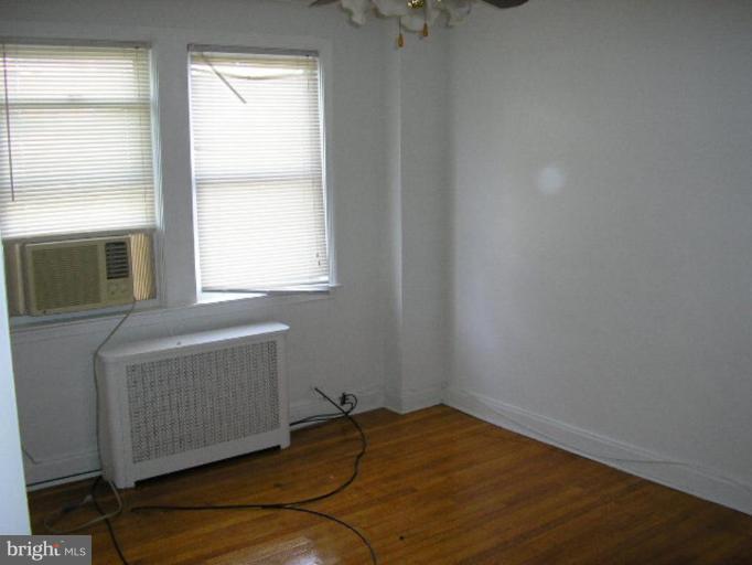 3912 Flowerton Road Baltimore, MD 21229 - Photo 3 of 8 a bedroom with a bed and a window