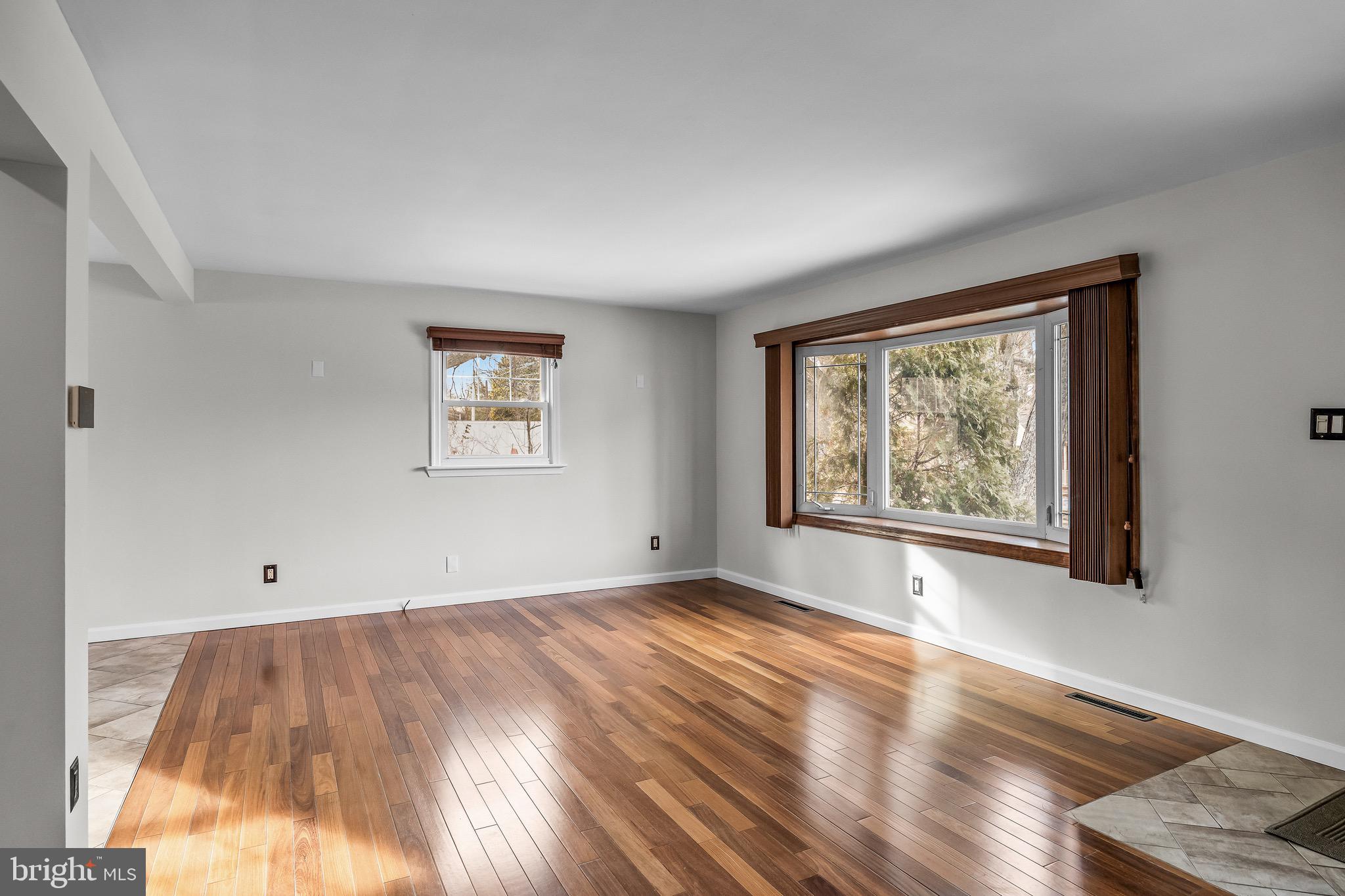 300 Copley Road Haddonfield, NJ 08033 - Photo 5 of 27 a view of an empty room with wooden floor and a window