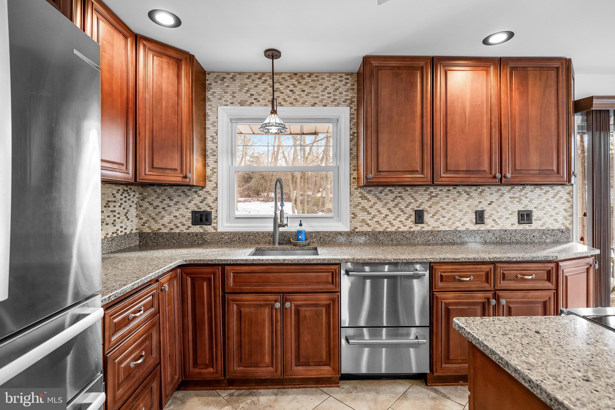 300 Copley Road Haddonfield, NJ 08033 - Photo 9 of 27 a kitchen with stainless steel appliances granite countertop a sink stove and cabinets