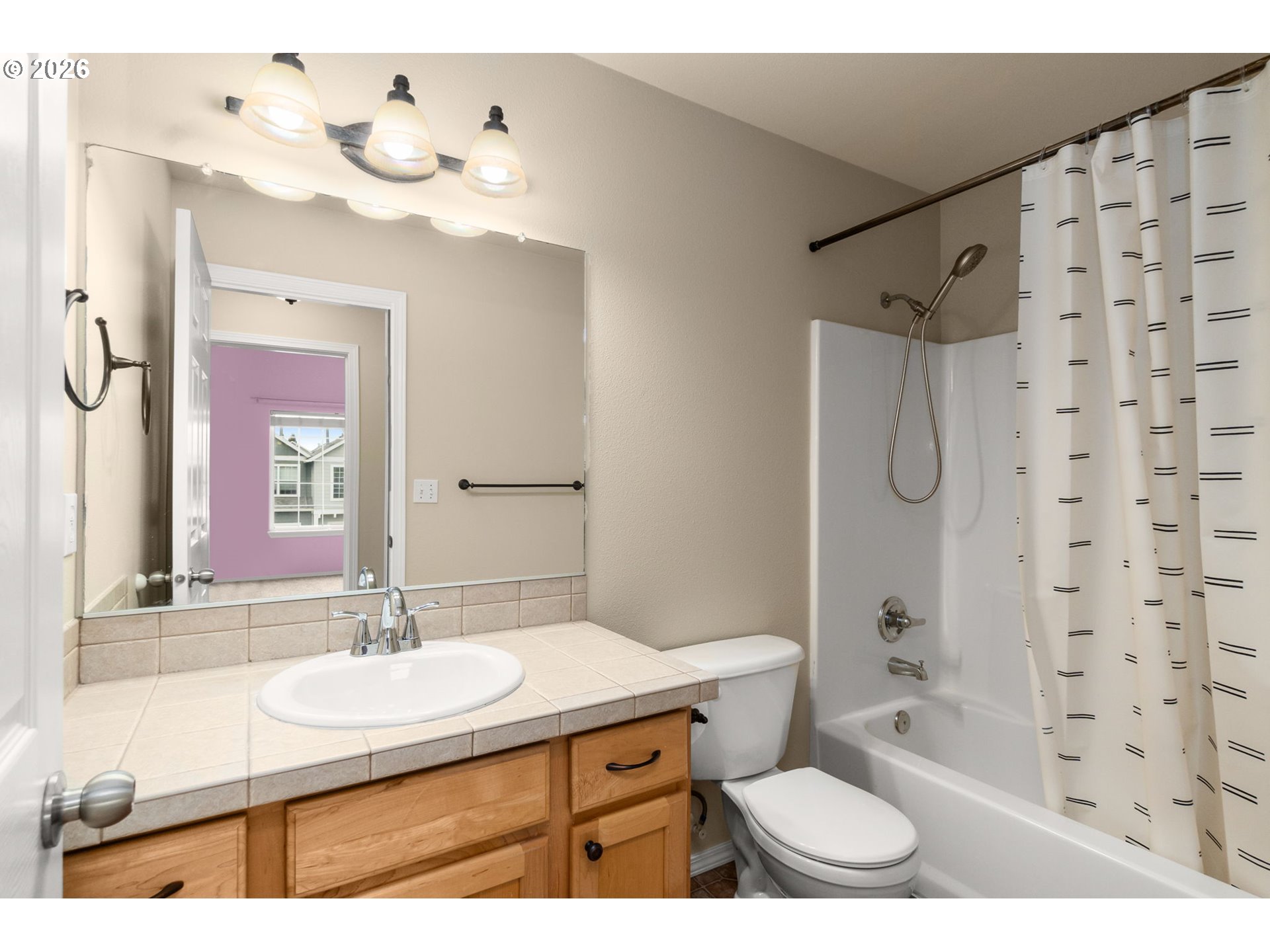 17428 Southwest September Lane Beaverton, OR 97003 - Photo 19 of 23 a bathroom with a sink a toilet a mirror a bathtub and shower