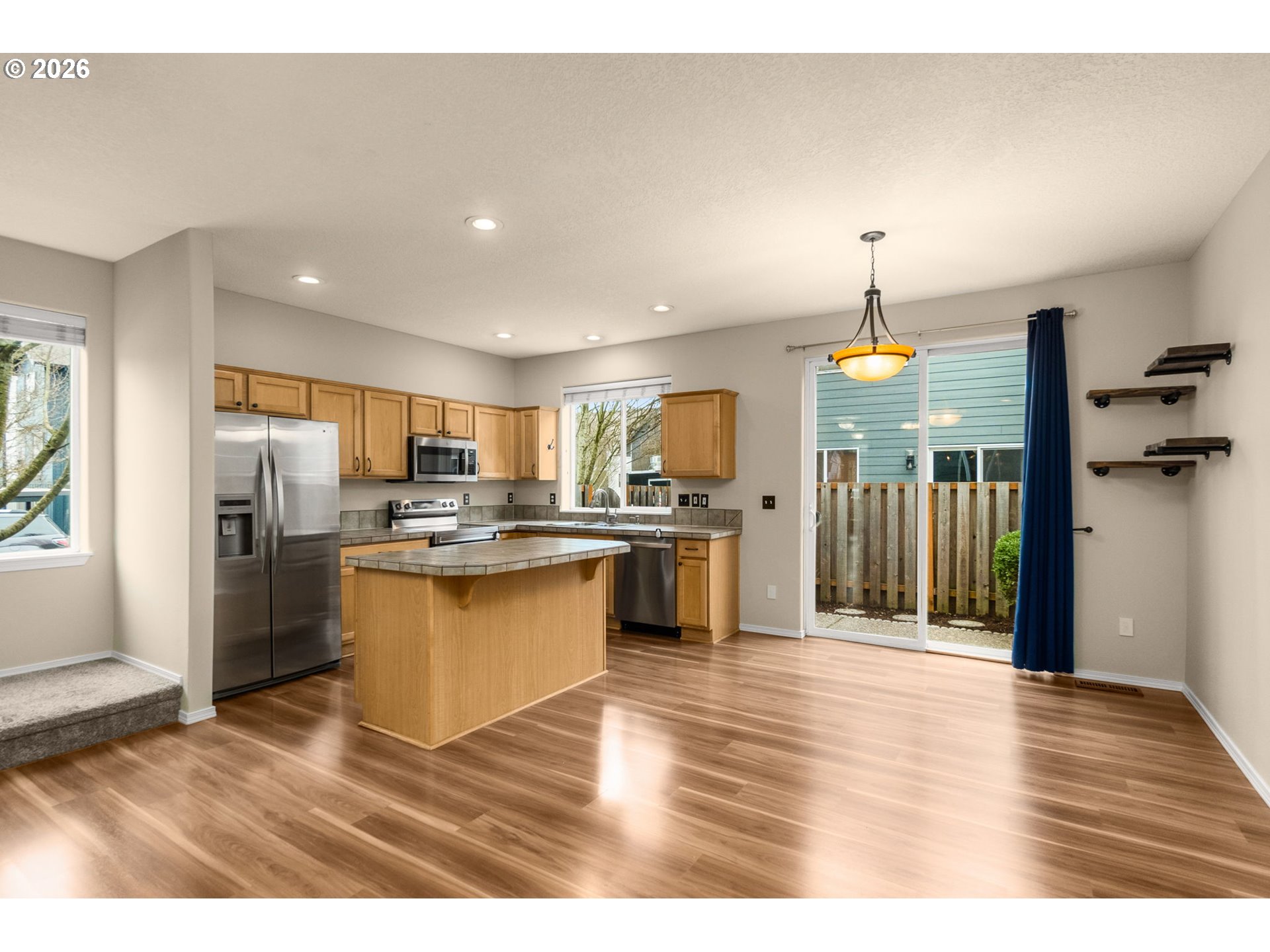 17428 Southwest September Lane Beaverton, OR 97003 - Photo 2 of 23 a kitchen with stainless steel appliances kitchen island granite countertop a refrigerator a sink a stove and oven