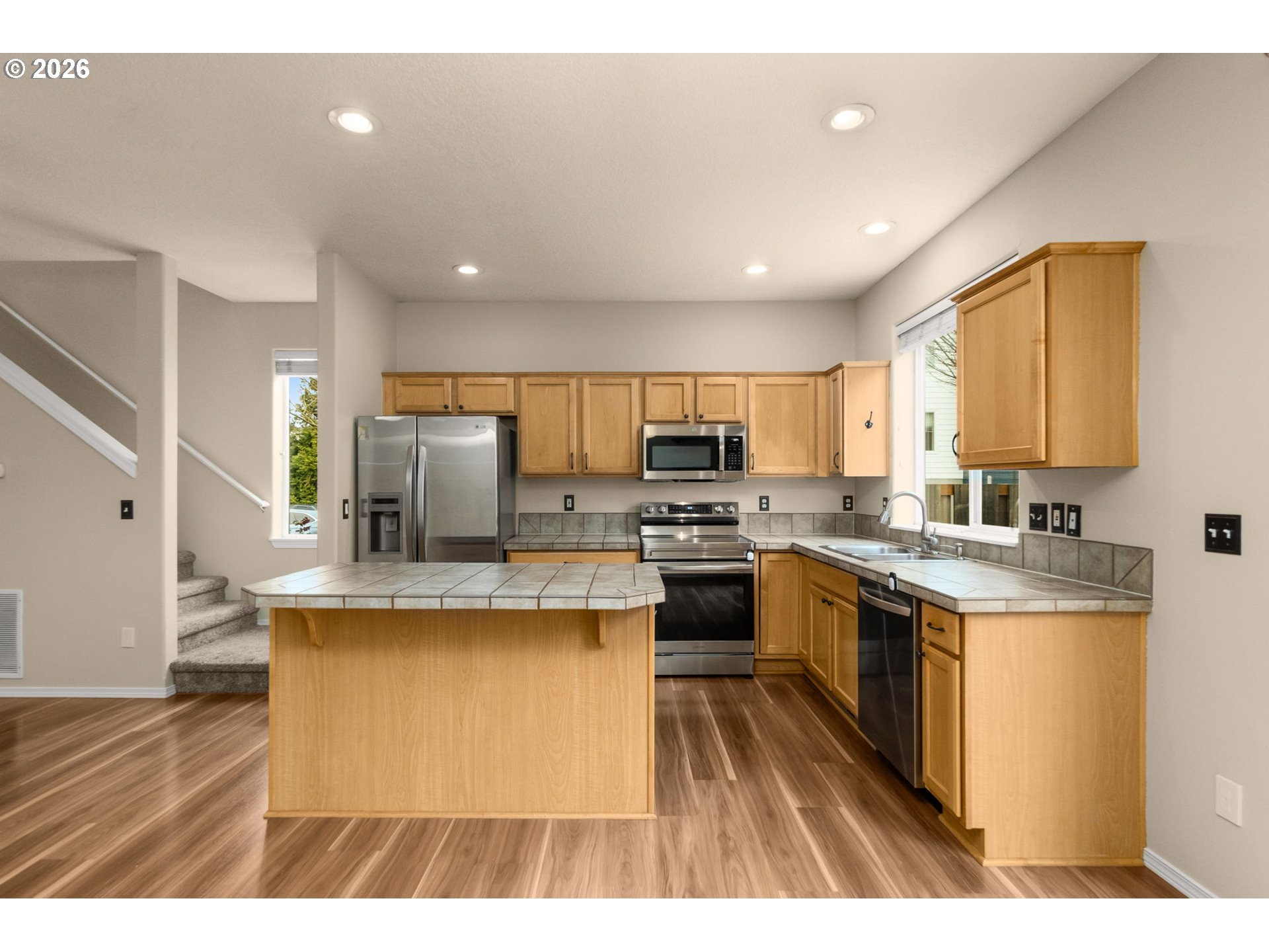 17428 Southwest September Lane Beaverton, OR 97003 - Photo 6 of 23 a kitchen with kitchen island stainless steel appliances a sink a stove top oven a counter space and cabinets