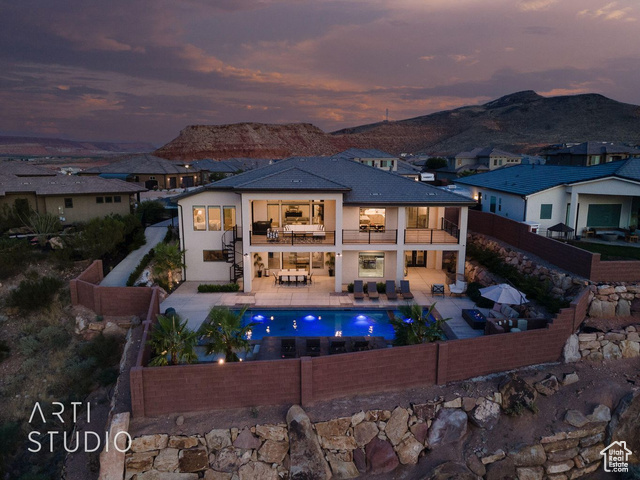 6026 Zen Trail Way St. George, UT 84790 - Photo 28 of 41 Rear view of property featuring a balcony, a fenced backyard, an outdoor living space, a patio, and a mountain view