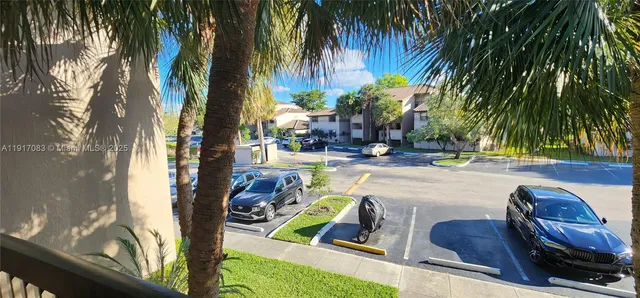 a view of a hallway with wooden floor and stairs
