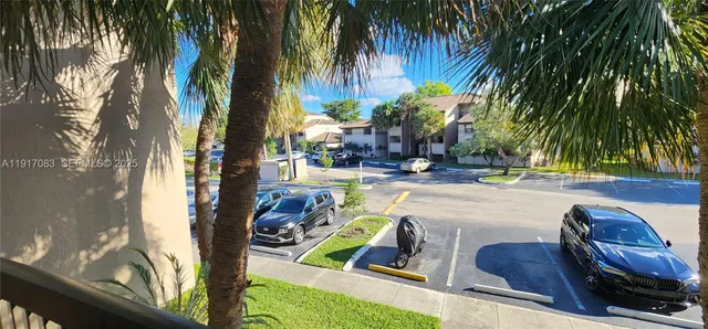 a view of a hallway with wooden floor and stairs