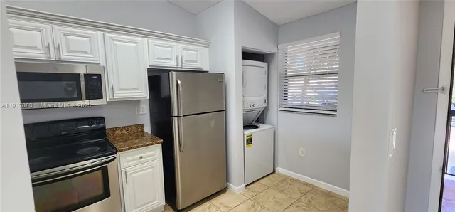 a kitchen with a refrigerator stove and microwave