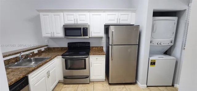 a kitchen with a refrigerator and a sink