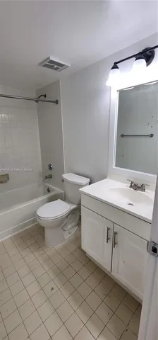 a bathroom with a sink toilet and mirror