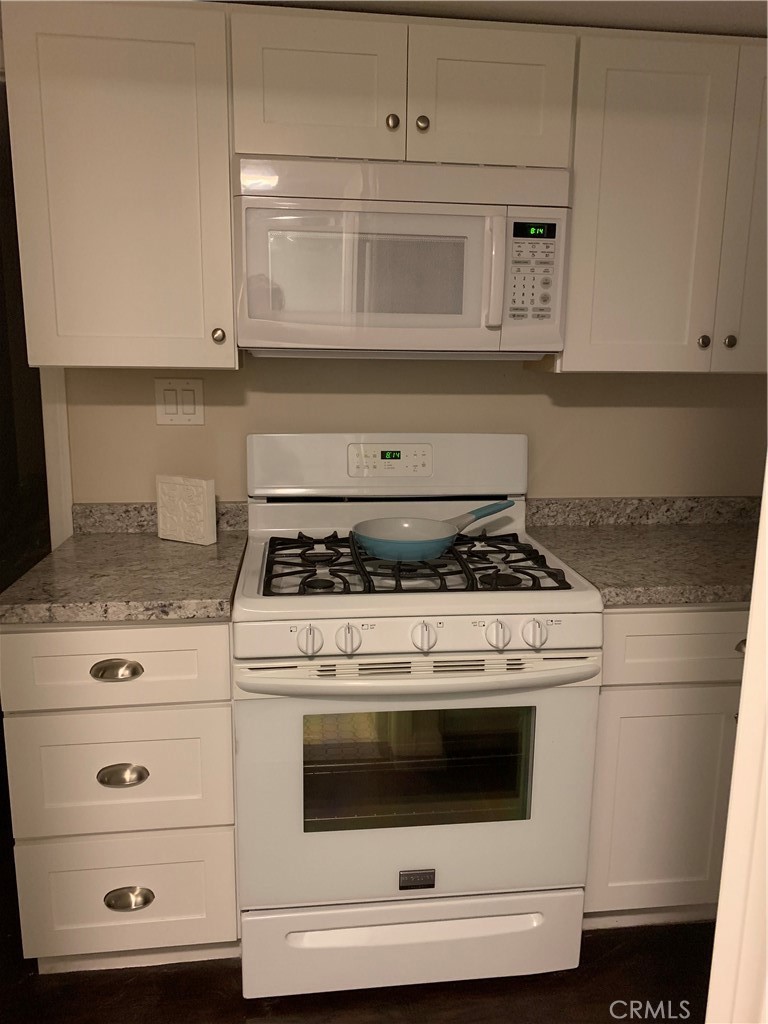 412 North Rose Avenue, Unit A Compton, CA 90221 - Photo 2 of 10 a stove top oven sitting inside of a kitchen
