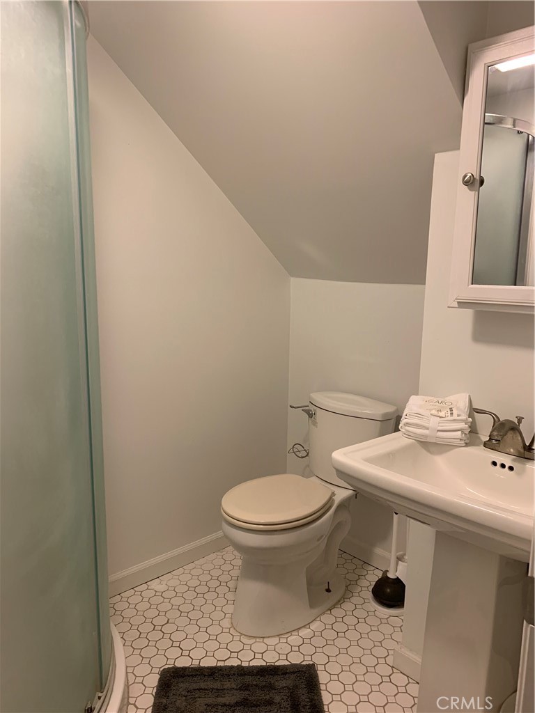 412 North Rose Avenue, Unit A Compton, CA 90221 - Photo 4 of 10 a bathroom with a sink toilet and mirror