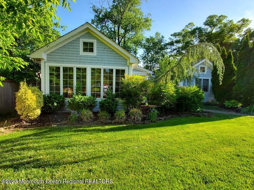 218 Bridge Avenue Point Pleasant Beach, NJ 08742 - Photo 1 of 19 a front view of a house with garden