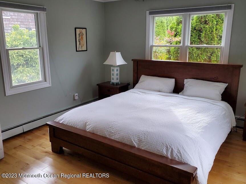 218 Bridge Avenue Point Pleasant Beach, NJ 08742 - Photo 11 of 19 a bed sitting in a bedroom next to a window