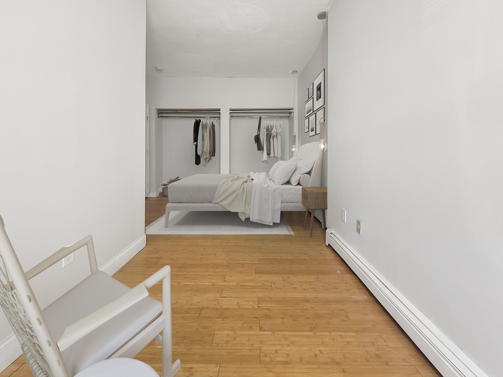 338-342 Warren Street, Unit 1 Boston, MA 02119 - Photo 7 of 10 a living room with furniture and a rug