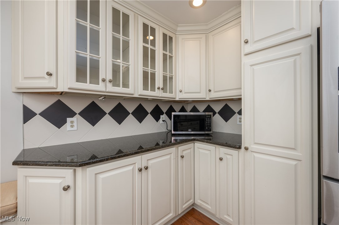 3721 20th Street Northwest Canton, OH 44708 - Photo 7 of 47 Kitchen featuring white cabinetry, decorative backsplash, and dark stone countertops
