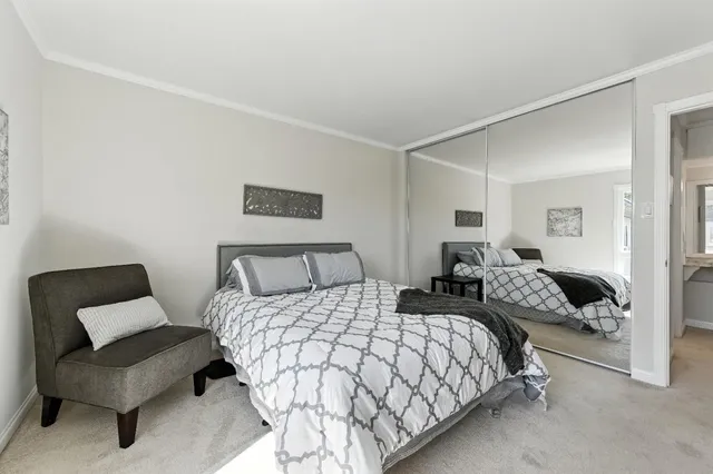 a bedroom with a bed and a couch