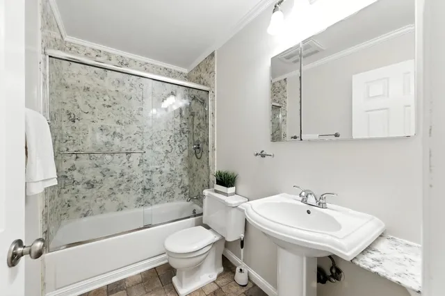 a bathroom with a sink toilet and shower