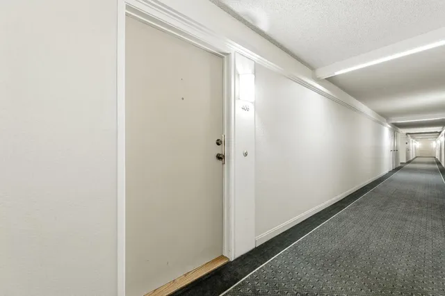 a view of living room with furniture and mirror