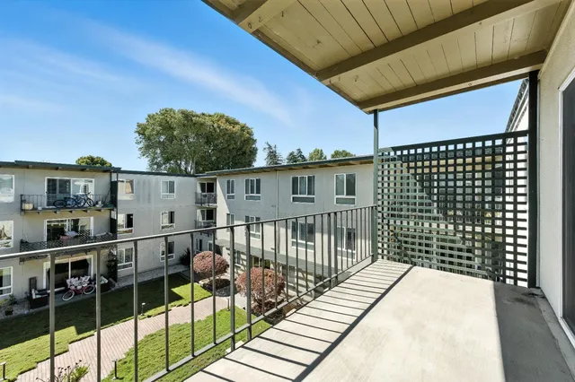 a view of a balcony with wooden floor