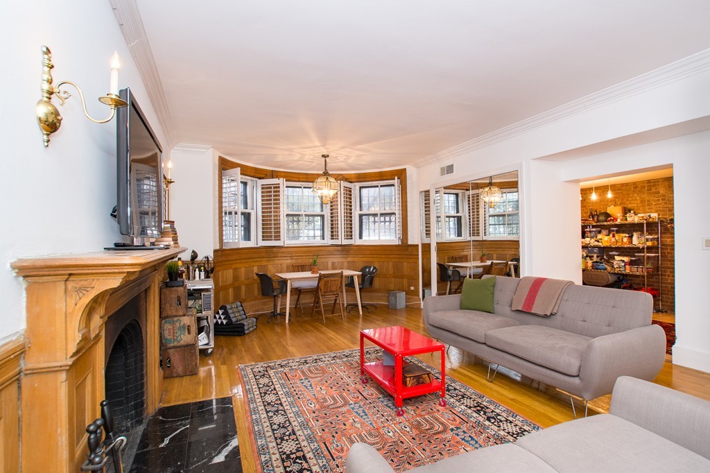 280 Commonwealth Avenue, Unit G9 Boston, MA 02116 - Photo 1 of 18 a living room with furniture a rug and a window