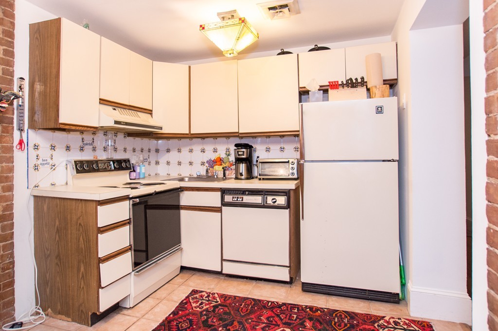 280 Commonwealth Avenue, Unit G9 Boston, MA 02116 - Photo 11 of 18 a kitchen with refrigerator and cabinets