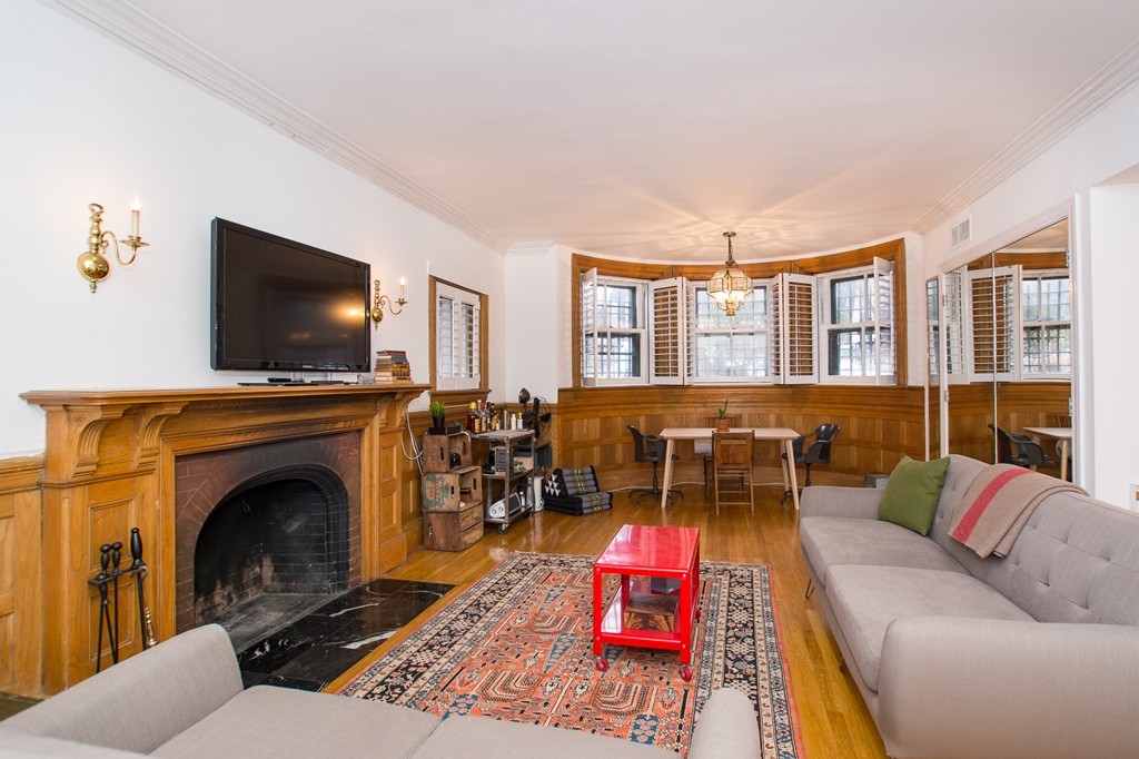 280 Commonwealth Avenue, Unit G9 Boston, MA 02116 - Photo 2 of 18 a living room with furniture and a fireplace