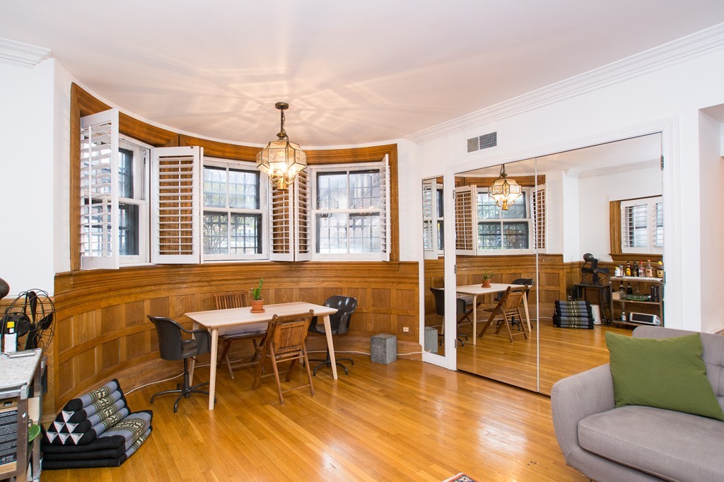 280 Commonwealth Avenue, Unit G9 Boston, MA 02116 - Photo 3 of 18 a dining room with furniture a chandelier and wooden floor