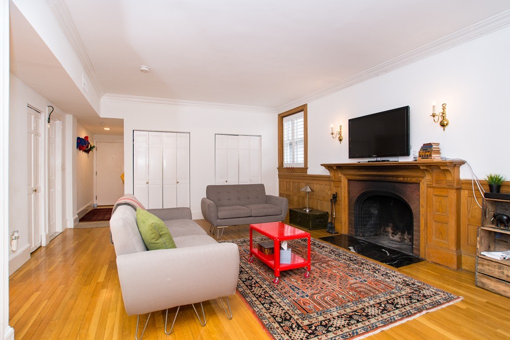 280 Commonwealth Avenue, Unit G9 Boston, MA 02116 - Photo 5 of 18 a living room with furniture and a fireplace