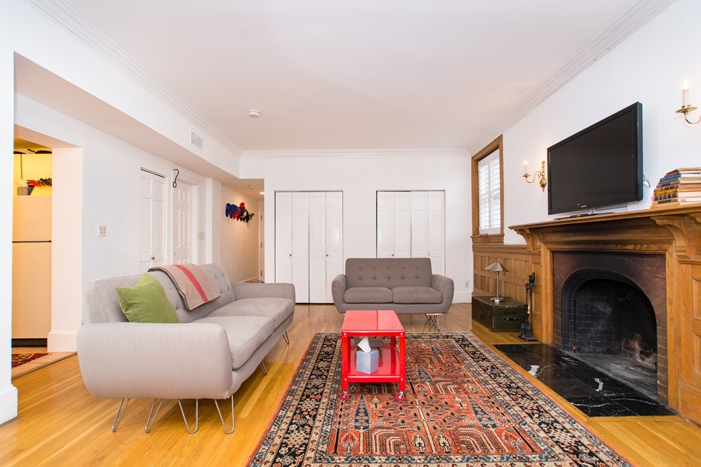 280 Commonwealth Avenue, Unit G9 Boston, MA 02116 - Photo 6 of 18 a living room with furniture and a fireplace